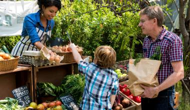 Family buying food at a farmer's market